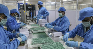 FILE -- Workers pack boxes of Covishield, the AstraZeneca-Oxford vaccine, in Pune, India., Jan. 14, 2021. The details of deals between drugmakers and the governments that have poured billions of dollars into development and purchase of the vaccines largely remain secret. (Atul Loke/The New York Times)