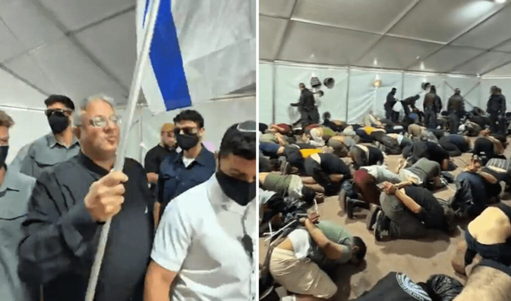 In ginocchio, con le fascette ai polsi mentre suona l’inno di Israele: ignobile. Non volgiamo lo sguardo altrove